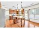 The well-lit kitchen features a large granite island, stainless steel appliances, and a view to the backyard at 2424 Malden Park Dr, Buford, GA 30519