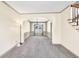 Open-concept living space with neutral carpet, wainscotting, and decorative columns at 2424 Malden Park Dr, Buford, GA 30519