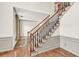 Elegant staircase featuring wood and iron railings with freshly painted walls at 2424 Malden Park Dr, Buford, GA 30519