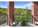 Relaxing balcony with outdoor seating, brick pillars and tranquil green views at 200 River Vista Dr # 423, Atlanta, GA 30339