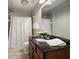 Full bathroom with shower curtain and granite counters at 200 River Vista Dr # 423, Atlanta, GA 30339