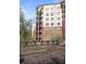 Apartment building exterior featuring balconies, brick accents, and lush greenery at 200 River Vista Dr # 423, Atlanta, GA 30339