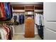 Walk-in closet with custom shelving and organization system at 200 River Vista Dr # 423, Atlanta, GA 30339