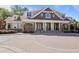 Elegant clubhouse exterior featuring stone columns, brick accents, and manicured landscaping at 200 River Vista Dr # 423, Atlanta, GA 30339