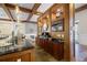 Coffee bar featuring granite counter, wood cabinets, and decorative lighting fixtures at 200 River Vista Dr # 423, Atlanta, GA 30339
