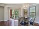 Bright dining area with modern light fixture, access to balcony and hardwood floors at 200 River Vista Dr # 423, Atlanta, GA 30339