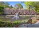 Brick townhomes overlooking a scenic pond with fountain and mature trees at 200 River Vista Dr # 423, Atlanta, GA 30339