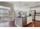 Open concept kitchen with stainless steel appliances, island and view to the living area at 200 River Vista Dr # 423, Atlanta, GA 30339
