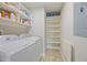 Well-equipped laundry room features both washer and dryer and ample shelving for storage at 200 River Vista Dr # 423, Atlanta, GA 30339