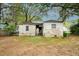 Rear view of the home showing a fenced yard and exterior details at 3074 Delowe Dr, Atlanta, GA 30344