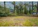 Large backyard featuring an expansive green space perfect for outdoor activities and gardening, surrounded by mature trees at 3074 Delowe Dr, Atlanta, GA 30344