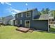 Spacious backyard featuring a wooden deck, bordered by a navy blue house and lush green lawn at 3455 Kingsbrooke Way, Decatur, GA 30034