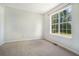 Bedroom with a large window offering natural light and a view of the outdoors at 3455 Kingsbrooke Way, Decatur, GA 30034