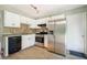 Bright kitchen features white cabinets, stainless steel appliances, and ample countertop space at 3455 Kingsbrooke Way, Decatur, GA 30034