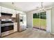 Kitchen features stainless appliances, white cabinetry, and a sliding glass door to backyard at 3455 Kingsbrooke Way, Decatur, GA 30034