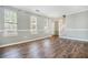 Spacious living room with new wood floors, large windows, and freshly painted neutral walls at 3455 Kingsbrooke Way, Decatur, GA 30034