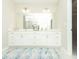 Well-lit bathroom features a double vanity with a large mirror and tiled floors at 3495 Delegate Aly, Scottdale, GA 30079