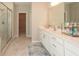 Modern bathroom with a double vanity, granite countertops, and a separate glass shower at 3495 Delegate Aly, Scottdale, GA 30079
