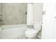 Bathroom with a new toilet, tub and shower, and tiled surround at 3495 Delegate Aly, Scottdale, GA 30079