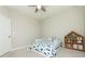 Bright bedroom with carpet, ceiling fan, toddler bed, and wooden bookshelf at 3495 Delegate Aly, Scottdale, GA 30079