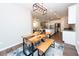 Open-concept dining area with custom wood table, stylish seating, and modern light fixture at 3495 Delegate Aly, Scottdale, GA 30079