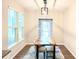 Bright dining room featuring a unique wood table, modern light fixture, and large windows at 3495 Delegate Aly, Scottdale, GA 30079