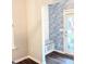 Stylish entryway with built-in bench, patterned wallpaper, and access to the outdoors at 3495 Delegate Aly, Scottdale, GA 30079