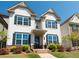 Charming two-story home with white siding, contrasting shutters, landscaped yard, and welcoming entryway at 3495 Delegate Aly, Scottdale, GA 30079