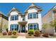 Charming two-story home with white siding, dark shutters, and a landscaped front yard at 3495 Delegate Aly, Scottdale, GA 30079