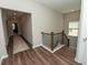 Upstairs hallway with hardwood floors, neutral walls, and natural light at 3495 Delegate Aly, Scottdale, GA 30079