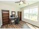 Bright home office featuring hardwood floors, desk, bookshelves, and a window with natural light at 3495 Delegate Aly, Scottdale, GA 30079