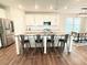 Open kitchen with granite island featuring seating, stainless steel appliances, and modern finishes at 3495 Delegate Aly, Scottdale, GA 30079