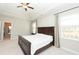 Bright main bedroom with tray ceiling, neutral carpet, and large windows with natural light at 3495 Delegate Aly, Scottdale, GA 30079