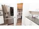 Modern kitchen featuring stainless steel refrigerator and walk-in pantry with shelving at 3495 Delegate Aly, Scottdale, GA 30079