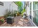 Cozy backyard patio featuring a brick floor, modern fire pit table, and a grill, perfect for outdoor entertaining at 74 Academy St, Alpharetta, GA 30009