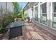 Inviting backyard patio with brick pavers, a contemporary fire pit table, and a barbecue grill, ideal for outdoor gatherings at 74 Academy St, Alpharetta, GA 30009