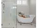 Modern bathroom design with shower, luxurious soaking tub and stylish gray and white tile work at 74 Academy St, Alpharetta, GA 30009