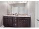 Bathroom boasts dual vanities with granite countertops and dark cabinetry with silver hardware at 74 Academy St, Alpharetta, GA 30009