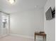 Bright bedroom with natural light, includes carpet, white walls, mounted TV and small desk at 74 Academy St, Alpharetta, GA 30009