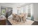 Bright dining area featuring designer chandelier, seating for six, and an open-concept layout at 74 Academy St, Alpharetta, GA 30009
