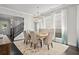 Bright dining area featuring designer chandelier, seating for six, and an open-concept layout at 74 Academy St, Alpharetta, GA 30009