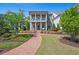 Beautiful two-story home with brick facade, inviting porch, and lush landscaping, creating a welcoming curb appeal at 74 Academy St, Alpharetta, GA 30009