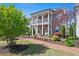 Stunning two-story home with brick accents, a charming porch, and meticulously maintained landscaping, showcasing its beauty at 74 Academy St, Alpharetta, GA 30009