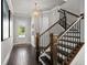Elegant foyer with hardwood floors, staircase and natural light from the front door at 74 Academy St, Alpharetta, GA 30009