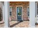 Charming front porch with brick facade, white pillars, and swing, offering a welcoming entrance to the home at 74 Academy St, Alpharetta, GA 30009