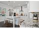 Beautiful kitchen with stainless appliances, a granite countertop island with seating and lots of cabinets at 74 Academy St, Alpharetta, GA 30009