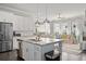 Bright kitchen features stainless steel appliances, island sink and peninsula seating open to the living room at 74 Academy St, Alpharetta, GA 30009