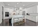 Spacious kitchen featuring white cabinets, an island with seating, and modern stainless steel appliances at 74 Academy St, Alpharetta, GA 30009