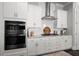 This kitchen has stainless steel oven and cooktop with white tile backsplash and lots of cabinets at 74 Academy St, Alpharetta, GA 30009