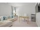 Bright living room featuring a sectional sofa, home office desk, carpet and mounted tv at 74 Academy St, Alpharetta, GA 30009